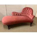 A pink button back chaise lounge on mahogany turned legs (H80cm W150cm D60cm)