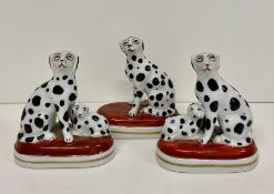 Three china figures of Dalmatians, one pair Staffordshire and one with gold anchor to base.