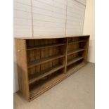 An antique pine open shelving unit (H118cm W252cm D39cm)