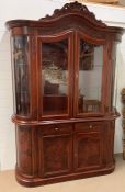 A glazed display cabinet with scrolled details to edges and double doors to base (H230cm W150cm