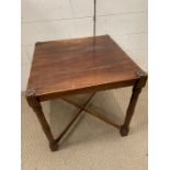 A small square mahogany side table with cross stretches (40cm x 40cm x 40cm)