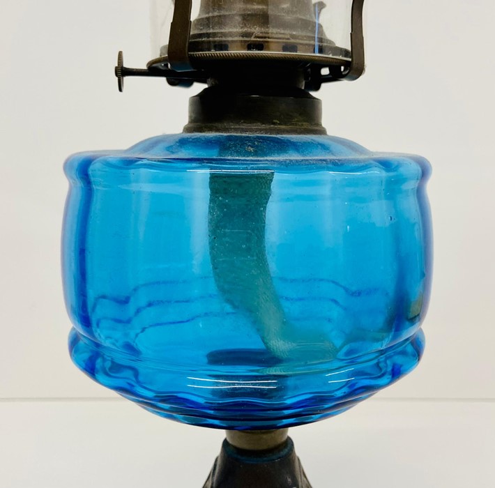 A cast iron and blue glass Art Nouveau oil lamp. - Image 2 of 4