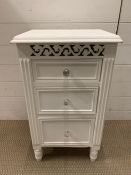 A white bedside cabinet