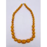 A graduated amber style necklace