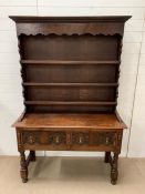 An oak hall table with carving to front and a plate rack wall unit, and brass drop handles AF