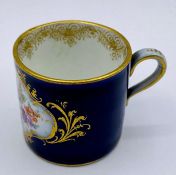 A Meissen miniature coffee cup, hand painted.