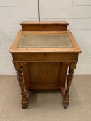 A Victorian Davenport, with a sloped top, fitted interior and four short drawers to side (H86cm