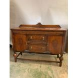 A mahogany sideboard with carved details to doors (H110cm W137cm D48cm)