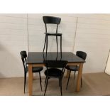 A granite top kitchen table with four Mid Century Italian black chairs (H74cm W110cm D70cm)