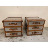 A pair of contemporary bedsides in a luggage trunk style with leather handles and metal case (