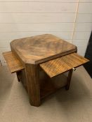 An Art Deco square table with four pull out shelves (59 cm square and 60 cm high)