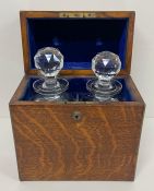 An Army Navy Decanter box, lined with blue velvet and with two crystal decanter's, makers name