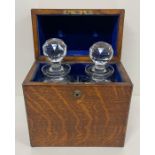 An Army Navy Decanter box, lined with blue velvet and with two crystal decanter's, makers name