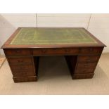 A large pedestal desk with green leather top flanked by drawers (H77cm W150cm D90cm)