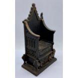 A 1953 cast iron throne moneybox