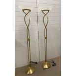 A pair of contemporary brass effect floor standing lamps with glass shades