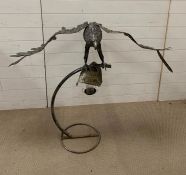 A sculpture of a flying bird on stand