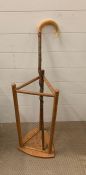 A Pine umbrella stand along with a sheep horn walking stick.