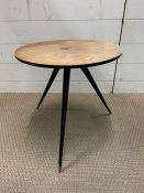 A Mid Century style table on tapered tri legs