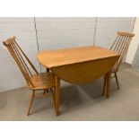An Ercol dining table and No 369 Goldsmith chairs