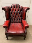 A oxblood wing back Chesterfield library chair