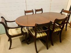 A mahogany dining table with string inlaid to edge and side chairs with carved twisted splat