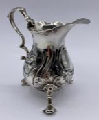 A Georgian silver milk jug with indistinct hallmarks.