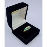 A 9ct gold diamond and emerald style ring (2.7g)