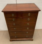 A mahogany tall chest of drawers with brass ring handles and bracket feet (H99cm W69cm D40cm)