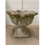 A garden planter with leaf design to side on stand (H46cm Dia47cm)