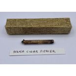 A silver cigar piercer