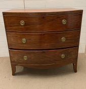 A bow fronted chest of drawers, three long drawers and brass ring handles (H98cm W102cm D48cm)