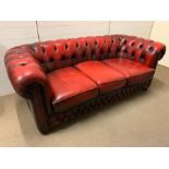 Three seater button back Chesterfield in oxblood (H66cm W184cmD85cm)