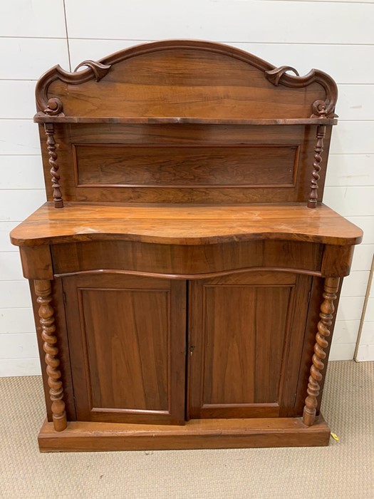 A small sideboard or serving table with barley twist pillars and cupboard to base (H136cm W103cm