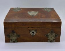 A wooden jewellery box with white metal decoration and cartouche