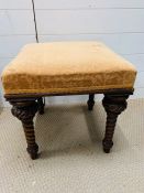 A foot stool on turned mahogany legs with clover carved into legs probably Irish