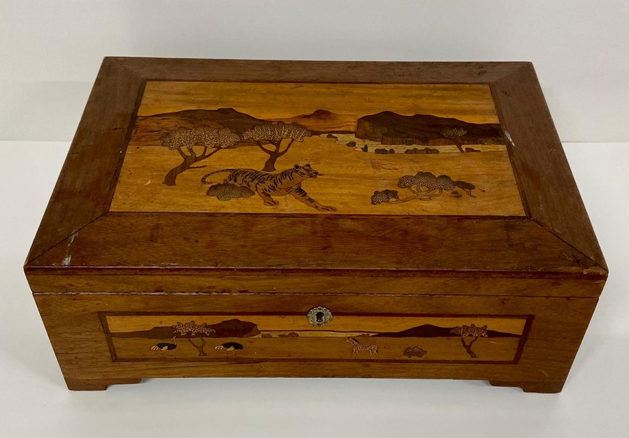 An inlaid wooden box with a savanna theme to the top and sides