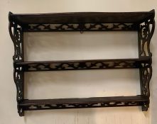 A mahogany three tier hanging wall shelf with pierced scroll work to side (H46cm W59cm D18cm)