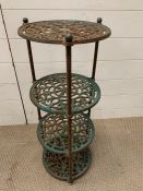 A cast iron four tier pot stand.