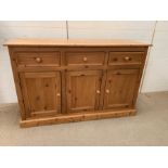 A Pine sideboard, three drawers over two cupboards. (H87cm W138cm D44cm)