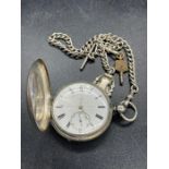 A Thomas Russel & sons silver pocket watch for Thavies Inn London and Albert chain and winder.