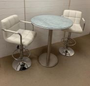 A round marble breakfast bar on chrome pillar and base with two leather bar stools (H98cm Dia80cm)