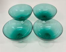 Four vintage green glass bowls on clear stems