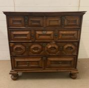 An oak chest of drawers on bun feet (H104cm W106cm D59cm)