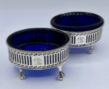 A Pair of silver salts with blue glass liners on four claw feet, possibly by Robert Hennell II dated