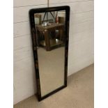 An ebonised inlay wall mirror