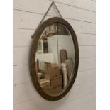 Arts and Crafts oval brass frame wall mirror