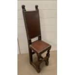 A late Victorian oak and leather correction chair (H92cm W25cm D25cm)