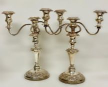 A pair of substantial three light silver on copper candlesticks