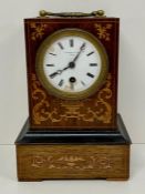 A mantel clock with decorative boxwood foliate inlay to front and sides with bronze gilt carrying